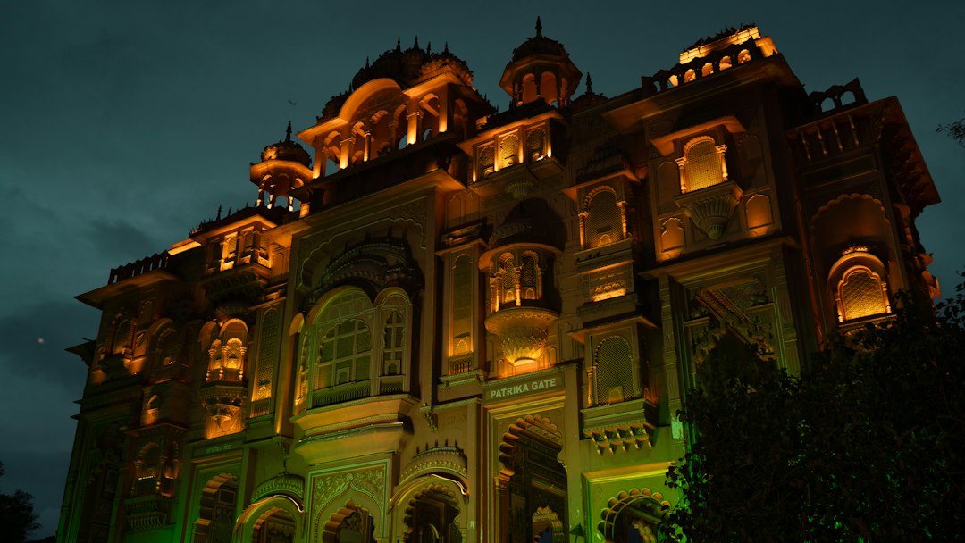 An ornate building illuminated with warm lights at night